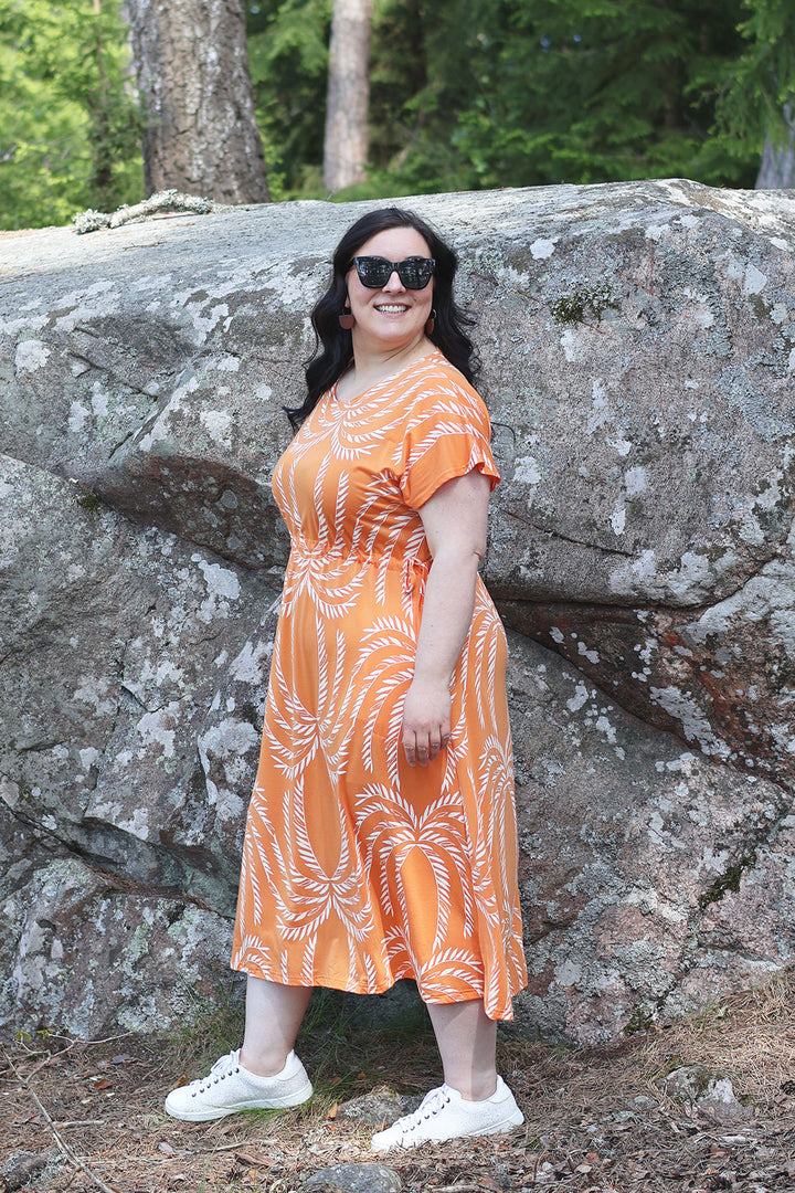 Oranssinvalkoinen Amy-neulosmekko Siivet-kuosilla koossa XXL. Mekossa on trendikäs Midi-mitta.